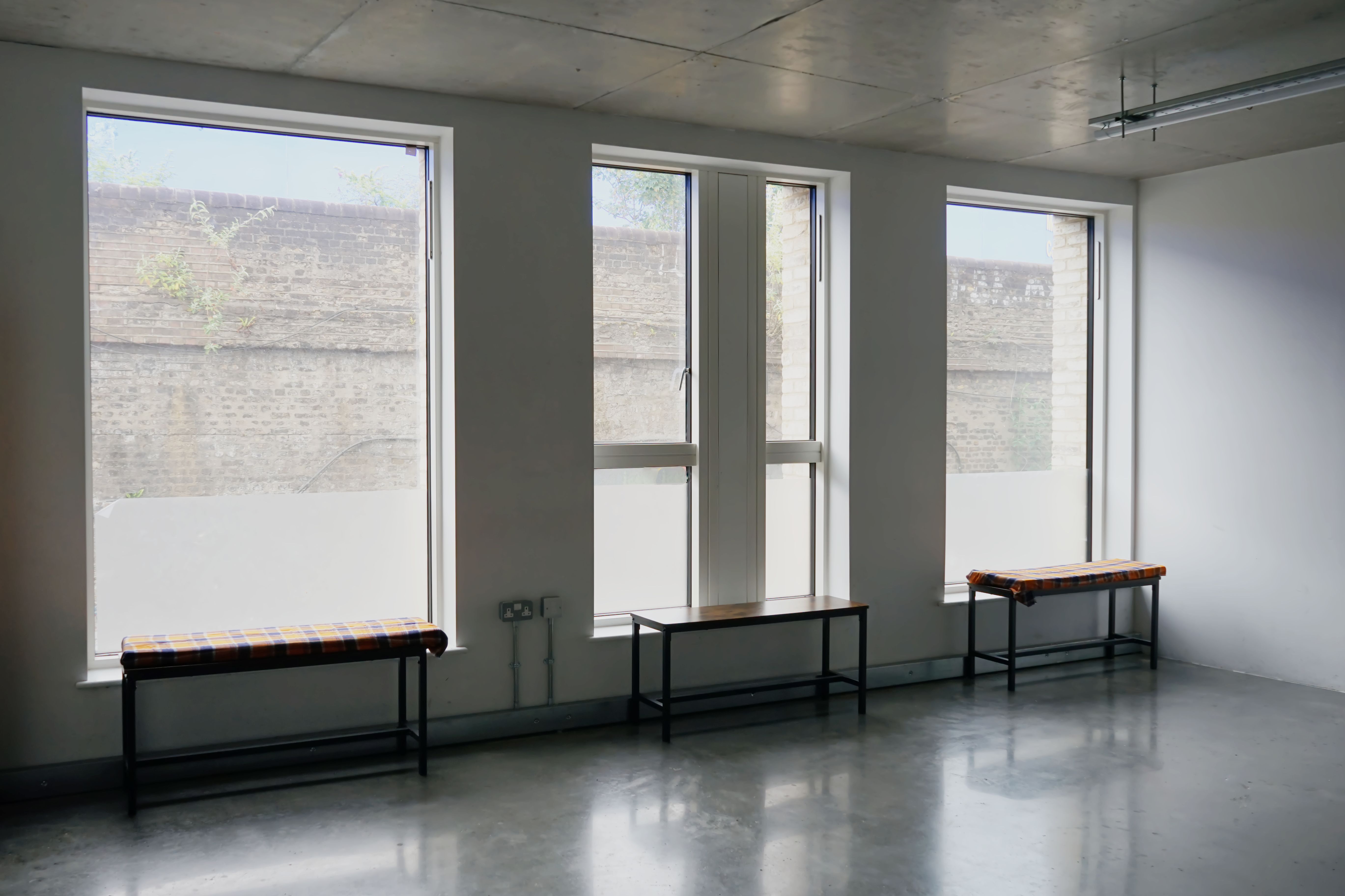 Studio / Rehearsal Room A large window with three benches in front of it